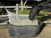 Freedom Feeder 125 lb 3-string bale net, slow feeder in tub on fence